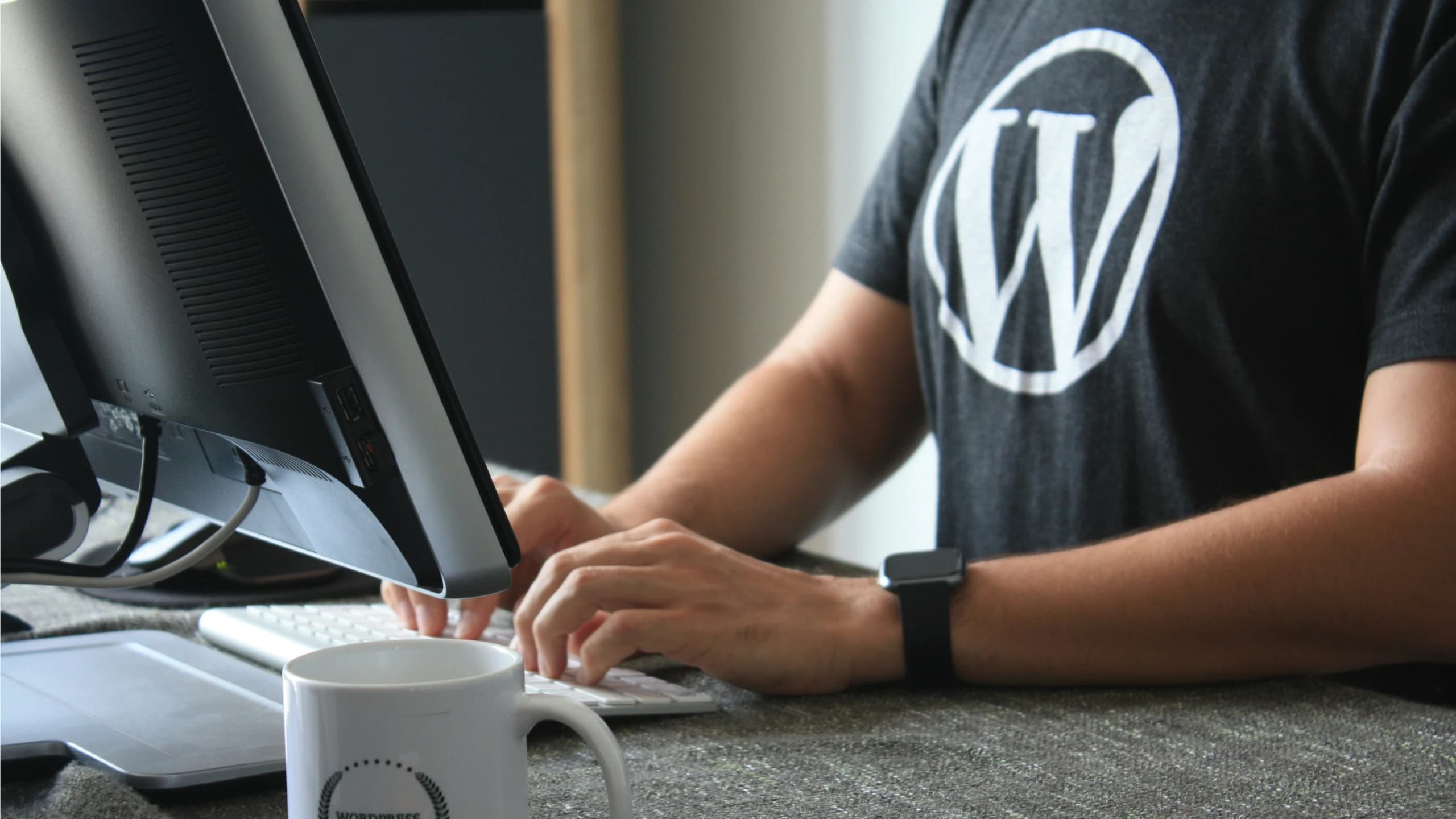 Designer working on WordPress site layouts on a laptop